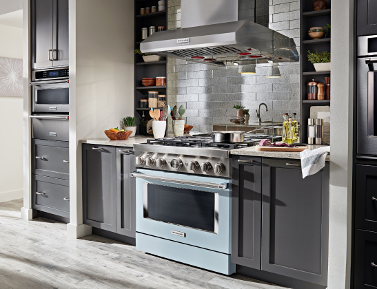 grey cabinets blue range with vent hood